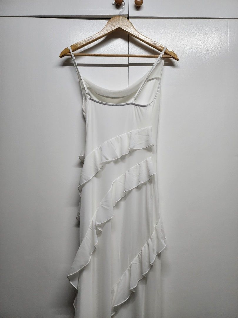 White Maxi Dress with Ruffles (Category: Dresses) located in Manila. Submitted by ybn15 (Listing ID 1466731685, Image 2). Description: Bought from Shein Only used during wedding prep shoot (very pretty and hugs your curves perfectly) Perfect for prep shoot if you don't want to wear bridal robe. Or for the beach - Style: Long slip-on dress - Color: Clean white - Straps: Spaghetti straps with adjustable sliders - Details: Diagonal ruffle tiers alon