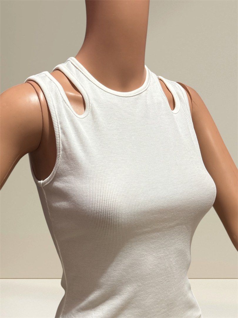 White ribbed tank top (Category: Sleeveless) located in Pasig City. Submitted by burtonxxx (Listing ID 1466668779, Image 2). Description: - Color: White - Style: Minimalist, fitted silhouette - Material: Stretchy ribbed knit - will fit 32-34 chest - Length 10 -color 10/10.