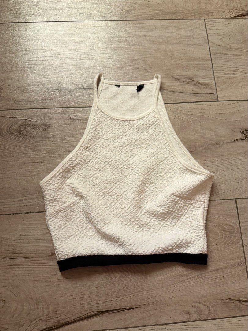 White textured halter crop top with black hem (Category: Sleeveless) located in Quezon City. Submitted by louviel (Listing ID 1466680769, Image 1). Description: - Tag got removed but i believe i got this from Zara! - Style: Halter crop top with high neckline - Design: Textured diamond pattern fabric with a contrasting solid black bottom hem - Material: Lightweight and breathable - Fit: Great for warmer weather and easy to style with high-waisted 