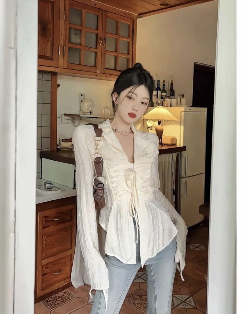 White textured tie-front long sleeve blouse (Category: Blouses) located in Baguio. Submitted by declutterbycys (Listing ID 1466569252, Image 1). Description: - Color: Cream white - Design: Textured vertical stripes with open V-neck collar and double front tie closures - Fit: Lightweight, sheer, and flowy draped fit - Sleeves: Long sleeves with stylish flared cuffs - Styling: Versatile neutral piece, great to pair with denim or skirts.