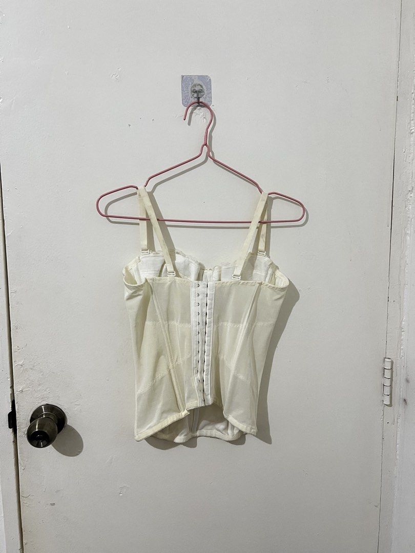 White vintage corset top (Category: Sleeveless) located in Quezon City. Submitted by http.ashi (Listing ID 1466673086, Image 2). Description: - Color: Cream - Style: Structured corset top with mesh panels - Closure: Front hook-and-eye - Straps: Adjustable with silver hardware - Details: Delicate lace trim along the top edge - With boning - Size XS-Small.