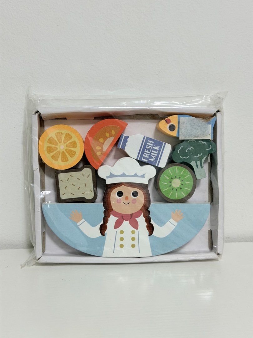 Wooden Balancing Stacking Chef Food Toy (Category: Educational & Learning Toys) located in Quezon City. Submitted by treasures.delight (Listing ID 1466577774, Image 1). Description: balance game cooking brand new & sealed price: ₱280 * This educational stacking game helps refine fine motor skills and hand-eye coordination as children carefully balance the food pieces on the chef base. It also encourages imaginative storytelling and introduces ear