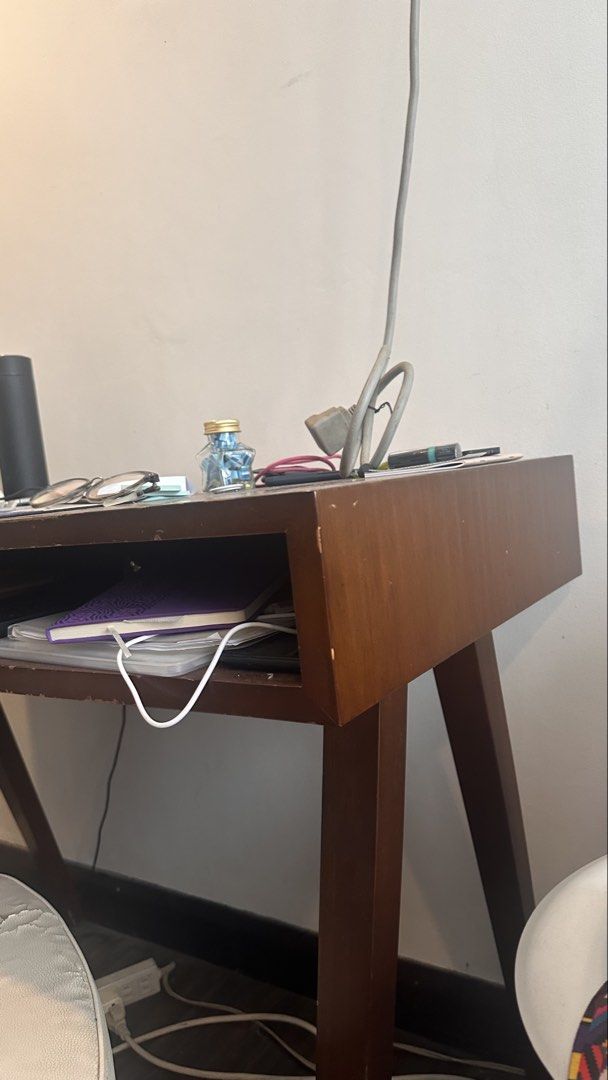Wooden Study Desk with Rolling Office Chair (Category: Office Furniture & Fixtures) located in Quezon City. Submitted by earthbender24 (Listing ID 1466587083, Image 3). Description: - Mid-century style wooden desk and matching rolling office chair set - Rich brown wood finish with classic angled legs - Desk includes a built-in open storage slot for books, notebooks, or a keyboard - Chair features a slatted backrest, armrests, and a comfortable pa