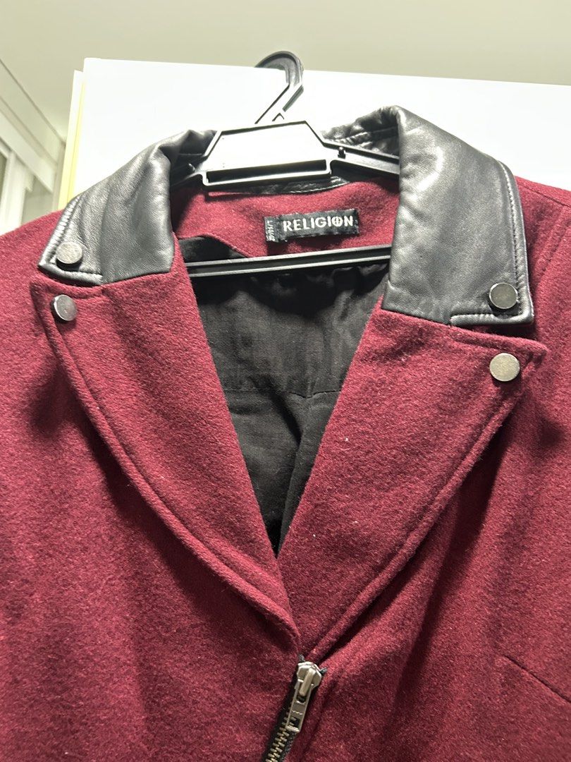Wool Jacket (Category: Coats, Jackets and Outerwear) located in Petaling Jaya. Submitted by megabytese (Listing ID 1466580246, Image 3). Description: - Brand: Religion - Material: Deep maroon wool blend - Accents: Contrasting black leather collar and pocket details - Closure & Pockets: Asymmetric front zip with front and side zippered pockets - Lining: Fully lined in black fabric - Size: L / 14 / 42 - Condition/Vibe: Great statement piece for coo