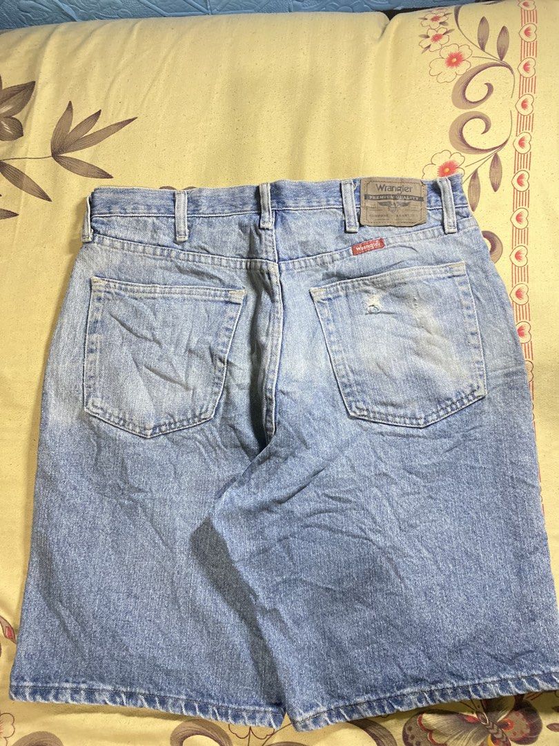 Wrangler denim shorts light wash (Category: Shorts) located in Bacolor. Submitted by paw_thrift (Listing ID 1466690190, Image 3). Description: - Brand: Wrangler - Style: Classic five-pocket denim shorts with button fly and belt loops - Wash: Light wash with a cool vintage look - Details: Features a leather brand patch, signature red tag, and a small stylish tear/distress mark near the right back pocket - Pairing: Versatile piece, easy to style wi