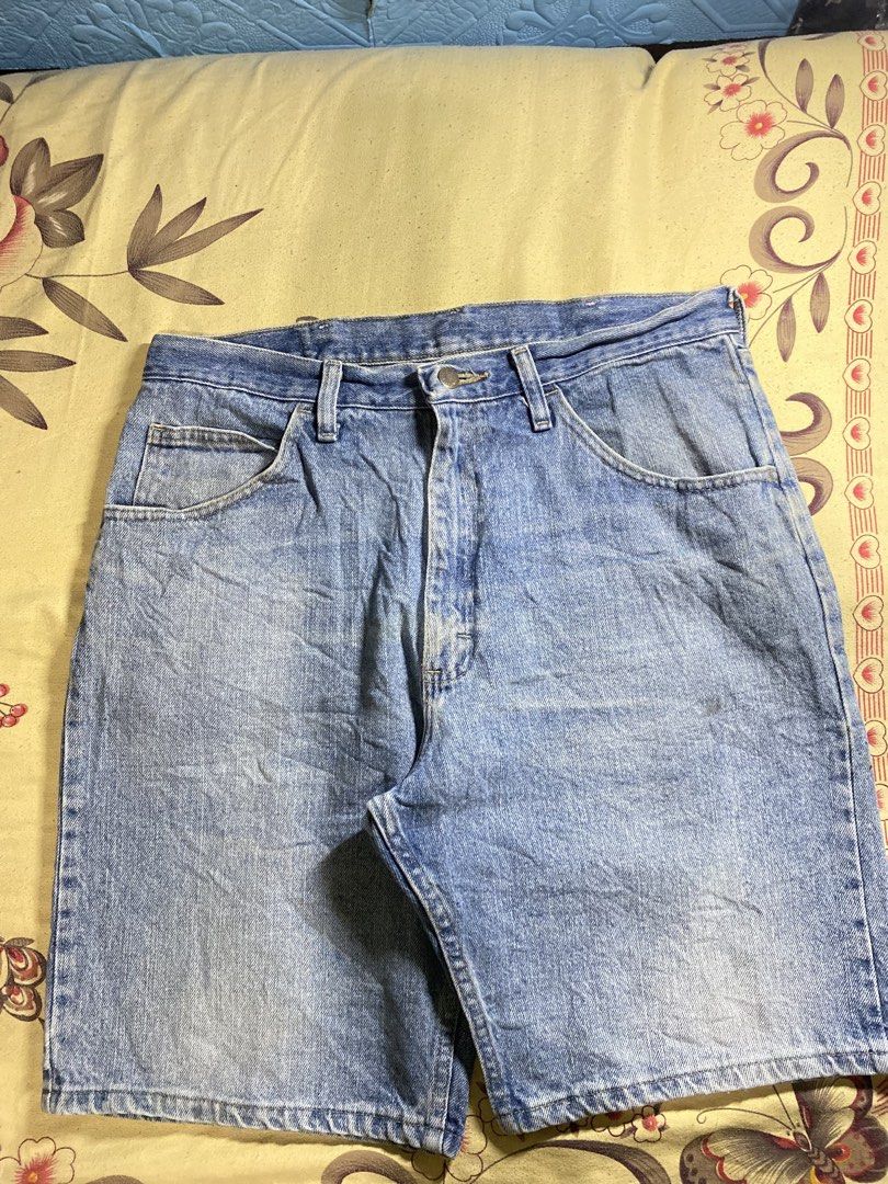 Wrangler denim shorts light wash (Category: Shorts) located in Bacolor. Submitted by paw_thrift (Listing ID 1466690190, Image 2). Description: - Brand: Wrangler - Style: Classic five-pocket denim shorts with button fly and belt loops - Wash: Light wash with a cool vintage look - Details: Features a leather brand patch, signature red tag, and a small stylish tear/distress mark near the right back pocket - Pairing: Versatile piece, easy to style wi