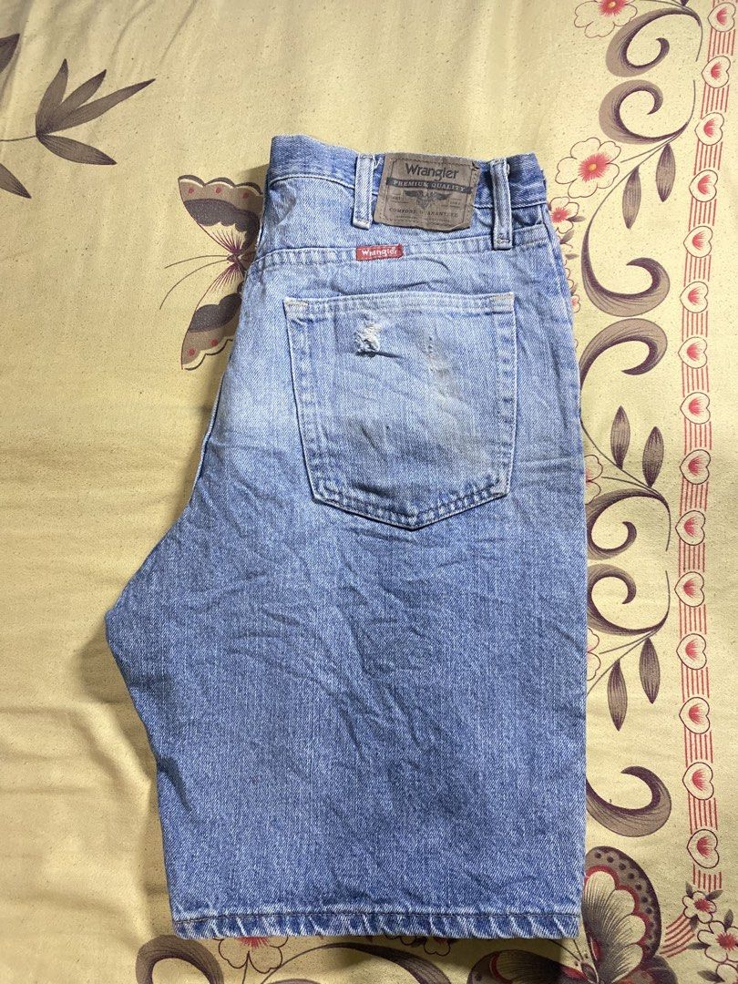 Wrangler denim shorts light wash (Category: Shorts) located in Bacolor. Submitted by paw_thrift (Listing ID 1466690190, Image 1). Description: - Brand: Wrangler - Style: Classic five-pocket denim shorts with button fly and belt loops - Wash: Light wash with a cool vintage look - Details: Features a leather brand patch, signature red tag, and a small stylish tear/distress mark near the right back pocket - Pairing: Versatile piece, easy to style wi