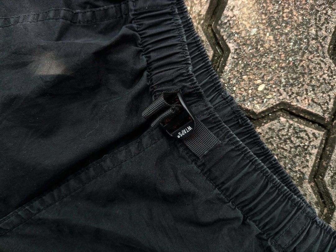 WTAPS Black Cargo Pants with Adjustable Waist (Category: Jeans) located in Manila. Submitted by pablo.405 (Listing ID 1466680471, Image 2). Description: - Brand: WTAPS - Color: Black - Style: Tactical cargo pants - Waist: Elastic with adjustable buckle strap and brand logo - Pockets: Multiple utility pockets on front and back - Details: Reinforced seat paneling and elastic ankle cuffs - Condition: Great pre-owned condition, perfect for streetwear