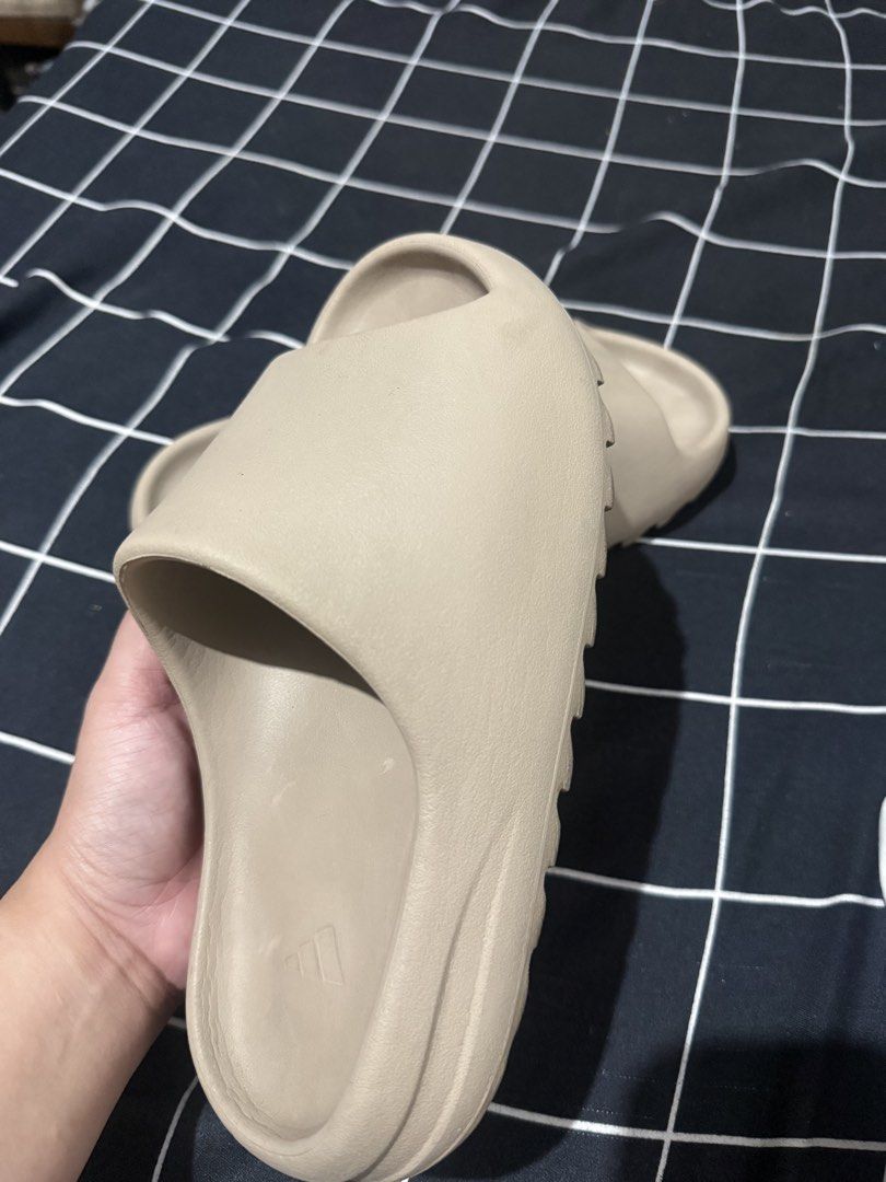 Yeezy Slides Authentic (Category: Slippers & Slides) located in Manila. Submitted by fnmvillaro10715 (Listing ID 1466567544, Image 3). Description: - Item: Yeezy Slides AUTHENTIC - Color: Beige - Size: 7 mens US (Made in India) - Design: Slip-on with textured foam construction and grooved soles - Condition: Worn a few times, clean and well-maintained - Perfect for daily casual wear -No box RFS: Decluttering.