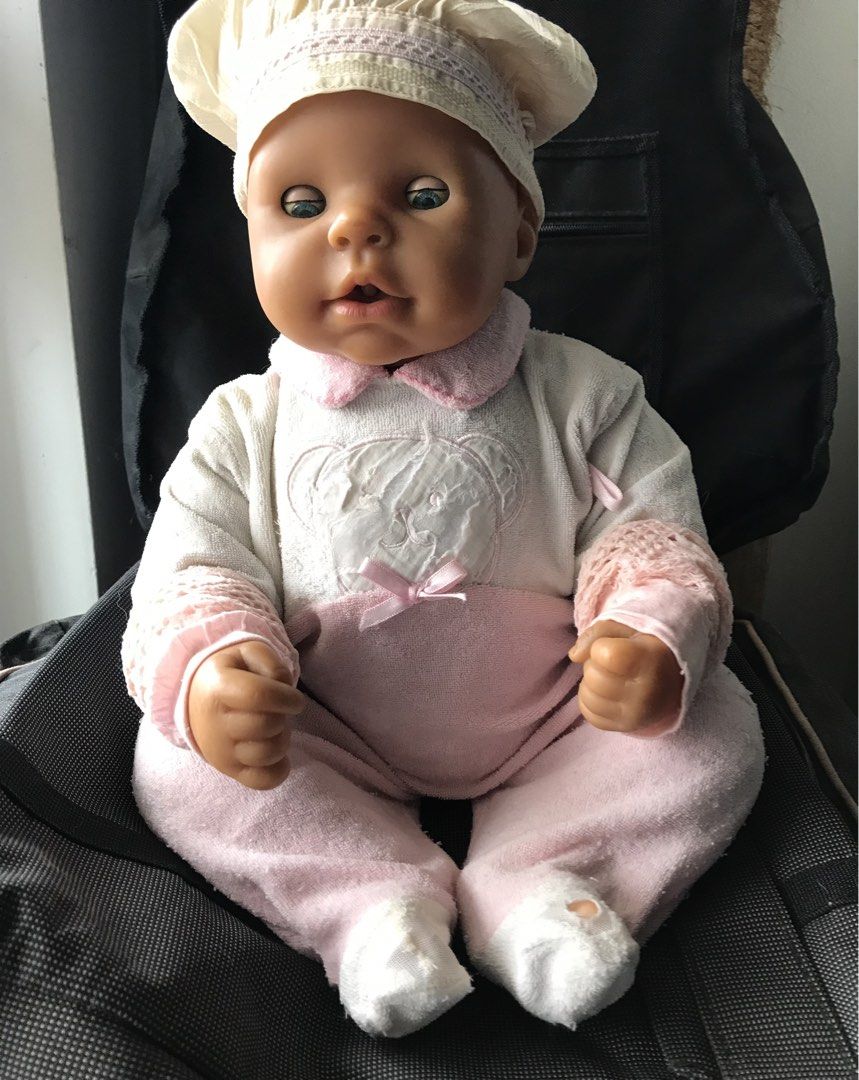 Zapf Creation Interactive Baby Doll with Stroller (Category: Babies & Kids Fashion) located in Quezon City. Submitted by 79moving (Listing ID 1466592925, Image 1). Description: - Authentic Zapf Creation baby doll - White and pink teddy bear top, matching pants, and chef-style hat - Body: Soft body construction for cuddling - Battery-operated mechanism / *NOT WORKING* (need repair) - Authenticity: Stamped branding on the back compartment - Well us