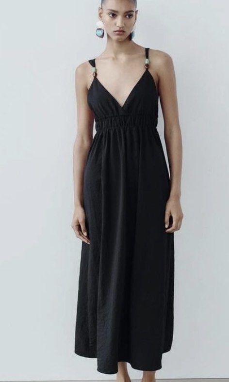 Zara Black Maxi Dress Size S (Category: Dresses) located in Balayan. Submitted by authenticfindsbymrb (Listing ID 1466700268, Image 3). Description: - Brand: Zara black maxi dress - Size: S - Design: V-neckline with decorative bead details on shoulder straps and a deep scoop back - Fit: Smocked elastic waist for a flattering fit and flare silhouette - Fabric: Flowy and lightweight, ideal for casual days or evening outings - Origin: Made in Cambod