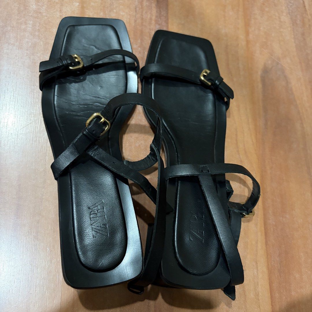 Zara Black Square Toe Strappy Heeled Sandals (Category: Heels) located in Manila. Submitted by tinggon (Listing ID 1466606145, Image 1). Description: - Brand: Zara - Style: Minimalist strappy sandals with square toes and block heels - Details: Gold-tone buckle closures on thin straps and ankle strap - Color: Black - Condition: Worn a few times, with slight creasing on the footbeds as shown in photos - Versatility: Easy to dress up or down for any