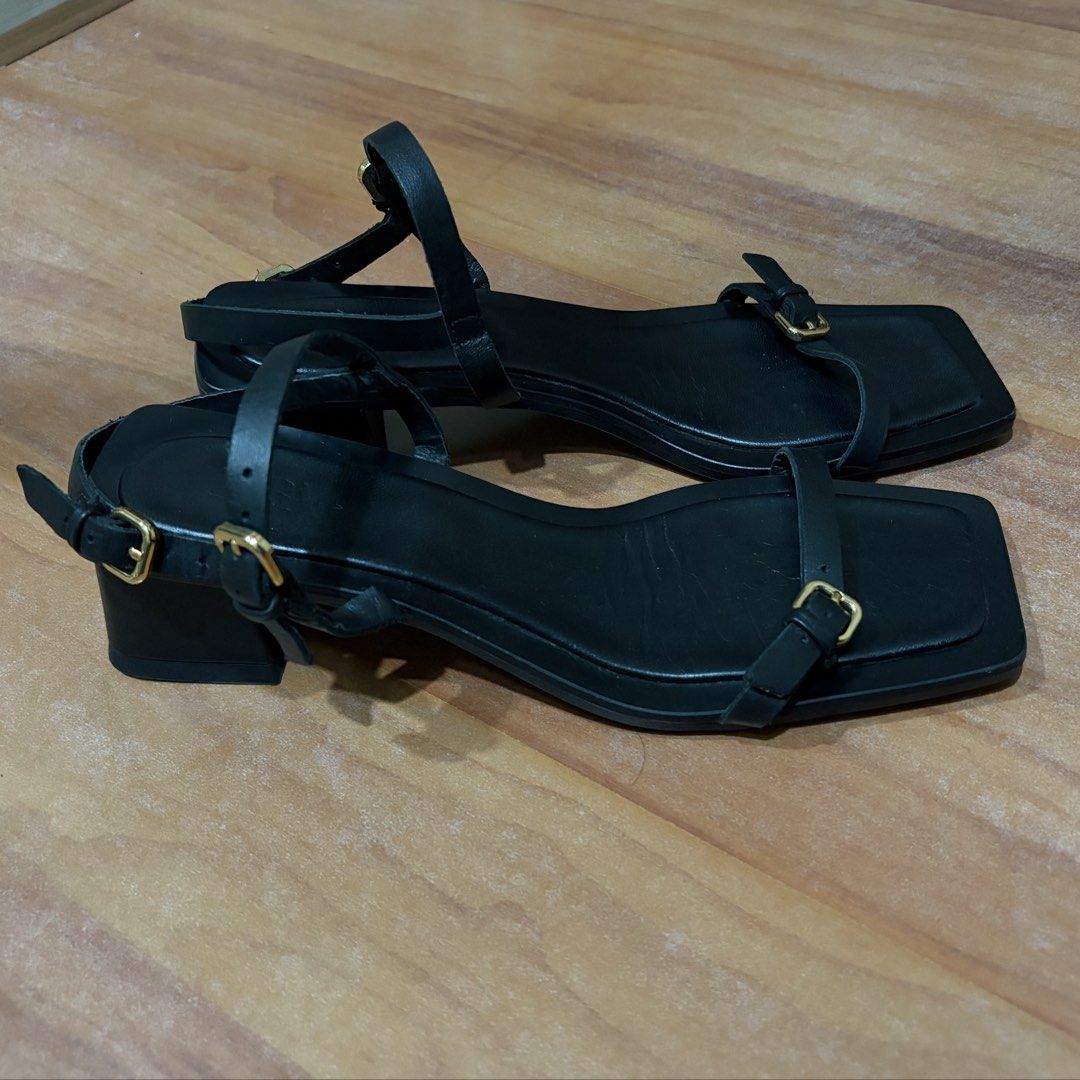 Zara Black Square Toe Strappy Heeled Sandals (Category: Heels) located in Manila. Submitted by tinggon (Listing ID 1466606145, Image 3). Description: - Brand: Zara - Style: Minimalist strappy sandals with square toes and block heels - Details: Gold-tone buckle closures on thin straps and ankle strap - Color: Black - Condition: Worn a few times, with slight creasing on the footbeds as shown in photos - Versatility: Easy to dress up or down for any