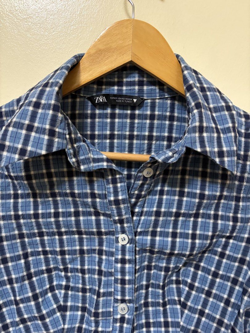 Zara Blue Plaid Long Sleeve Button-Down Shirt (Category: Longsleeves) located in Makati City. Submitted by sbllia (Listing ID 1466610160, Image 3). Description: - Brand: Zara - Size: XS - Color/Pattern: Blue and black plaid - Fit: Fitted cut with curved hem - Details: Button-down front, collar, long sleeves - Origin: Made in Turkey.