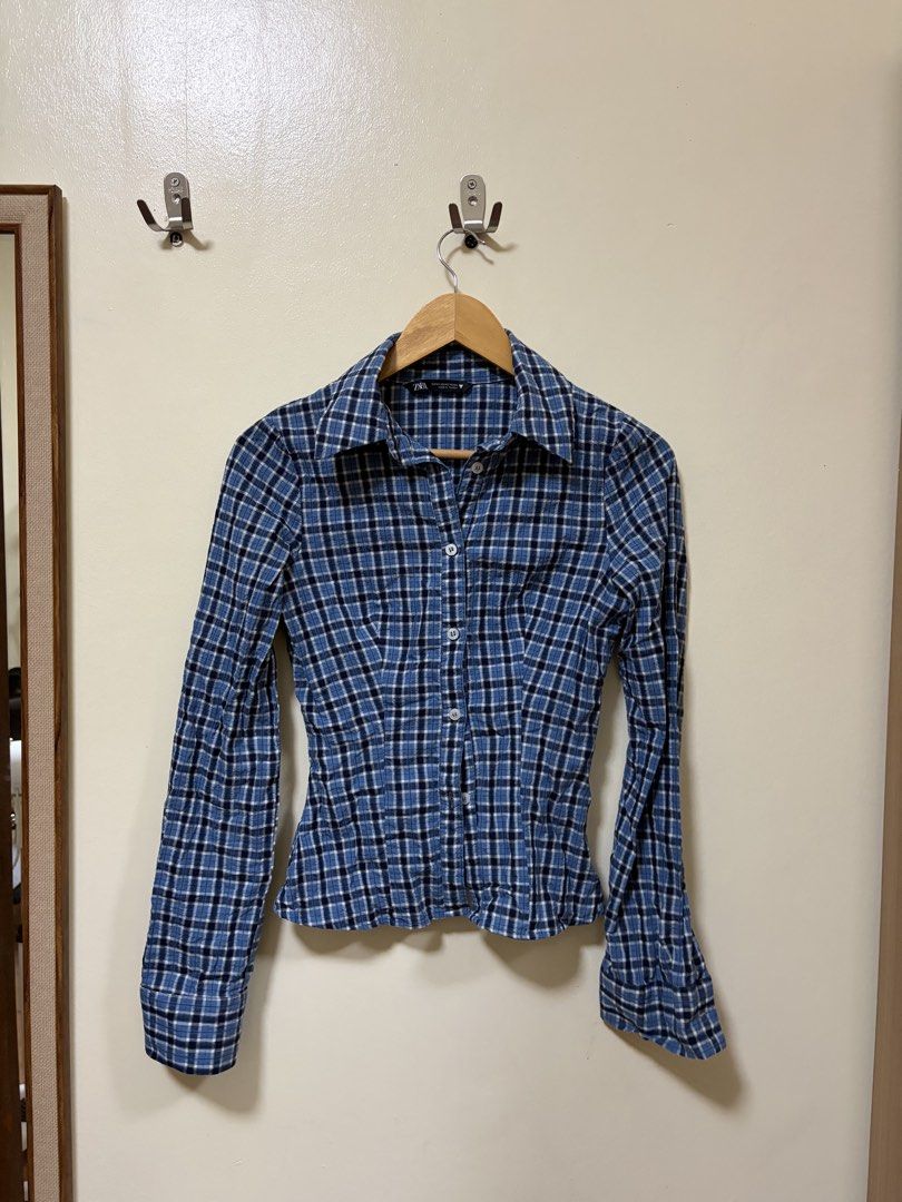 Zara Blue Plaid Long Sleeve Button-Down Shirt (Category: Longsleeves) located in Makati City. Submitted by sbllia (Listing ID 1466610160, Image 1). Description: - Brand: Zara - Size: XS - Color/Pattern: Blue and black plaid - Fit: Fitted cut with curved hem - Details: Button-down front, collar, long sleeves - Origin: Made in Turkey.