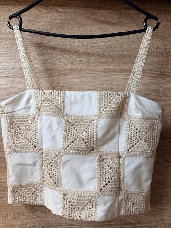 ZARA crochet patch crop top (Category: Sleeveless) located in Pasig City. Submitted by jultzn (Listing ID 1466715549, Image 2). Description: - Brand: ZARA - Style: Cropped camisole top with square neckline and thin straps - Design: Checkered pattern combining plain cream fabric and crochet knit squares.