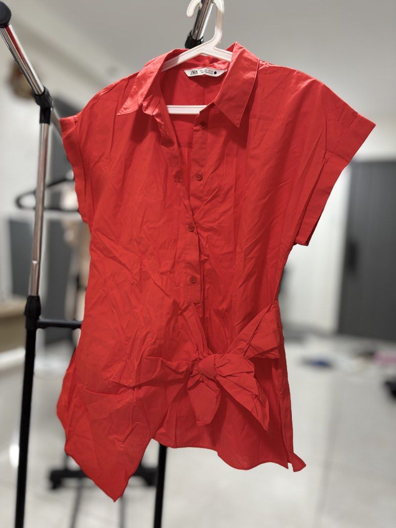 ZARA Red Short Sleeve Button Down Blouse Size L (Category: Blouses) located in Pasay City. Submitted by altheatheaaeia (Listing ID 1466685280, Image 1). Description: - Brand: Zara - Color: Bright Red - Size: EUR L / USA L / MEX 30 - Features: Short sleeves, collar, front button-down, and a cute tied bow detail at the hem - Origin: Made in Morocco - Condition: Great piece for casual or smart-casual wear!.