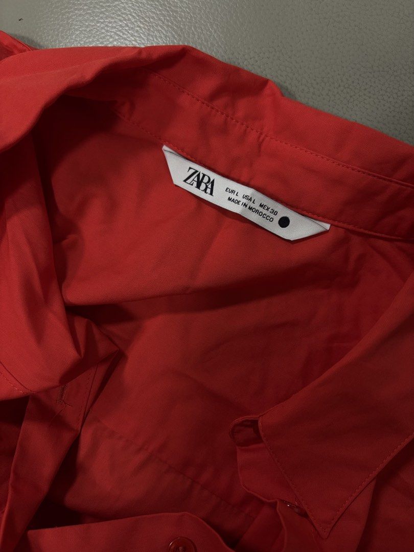 ZARA Red Short Sleeve Button Down Blouse Size L (Category: Blouses) located in Pasay City. Submitted by altheatheaaeia (Listing ID 1466685280, Image 2). Description: - Brand: Zara - Color: Bright Red - Size: EUR L / USA L / MEX 30 - Features: Short sleeves, collar, front button-down, and a cute tied bow detail at the hem - Origin: Made in Morocco - Condition: Great piece for casual or smart-casual wear!.