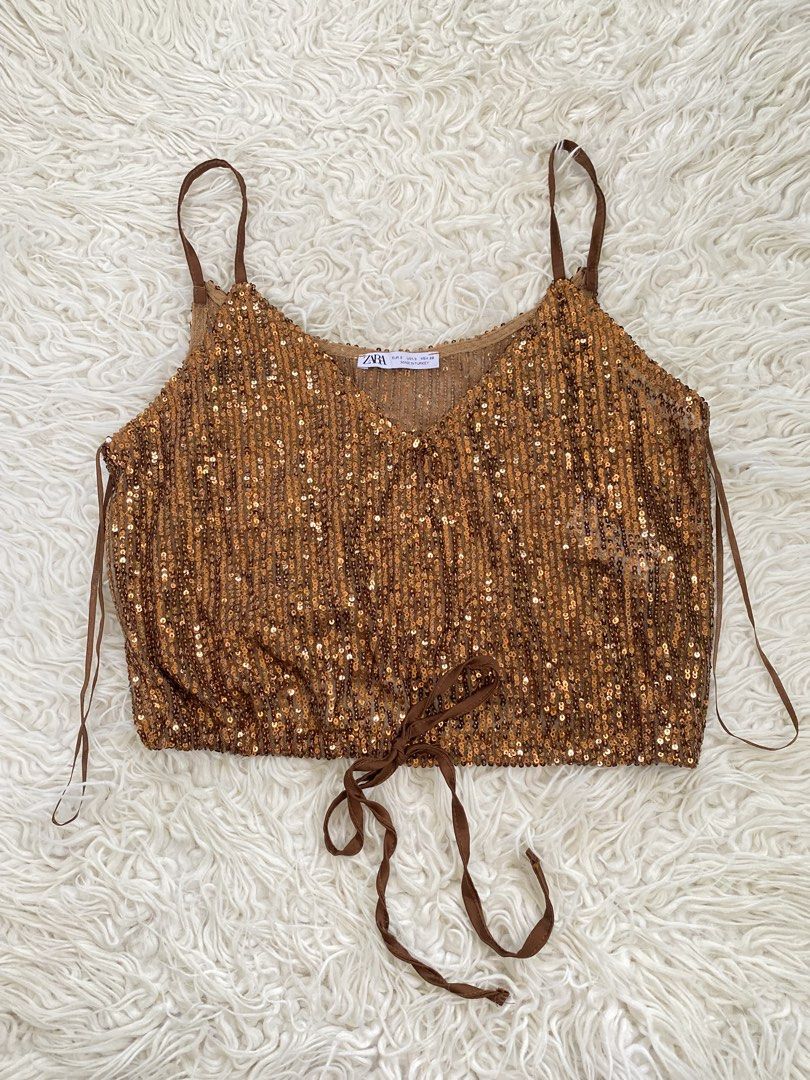 Zara Sequined Brown Crop Top Size S (Category: Sleeveless) located in Tabaco. Submitted by camila_p (Listing ID 1466699712, Image 1). Description: - Brand: Zara - Size: S (EUR/USA/MEX) - Color: Rich bronze brown - Material: Semi-sheer mesh covered in sparkling sequins - Details: Thin adjustable straps, v-neckline, satin ribbon ties at the bottom hem - Origin: Made in Turkey - Condition: Great party piece / statement going out top/ Brand New/ Tag 