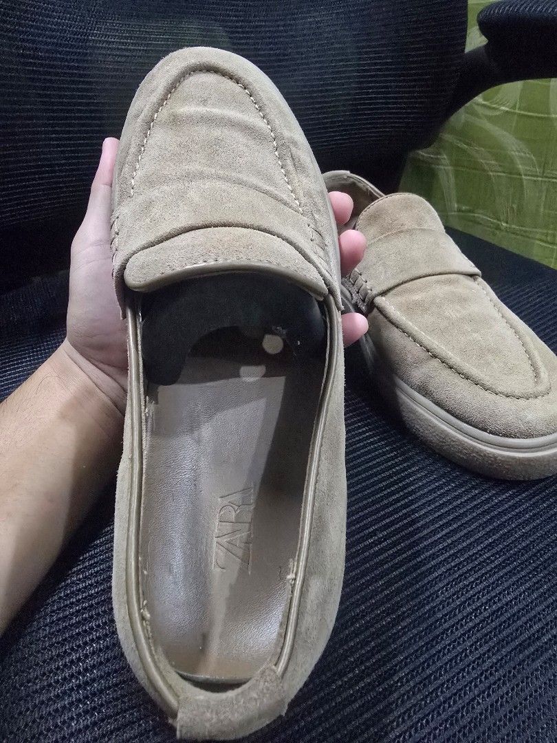 Zara Suede Slip-on Loafers Size 41 (Category: Casual Shoes) located in Manila. Submitted by manilagamers (Listing ID 1466566253, Image 3). Description: - Brand/Model: Zara Suede Slip-On Loafers - Color: Brown - Size: 41 - Design: Classic penny loafer with moc toe stitching and flat rubber sole - Condition: Uppers are in decent shape; bottom soles show dirt and wear from previous use - Style: Convenient slip-on design, perfect for casual everyday 