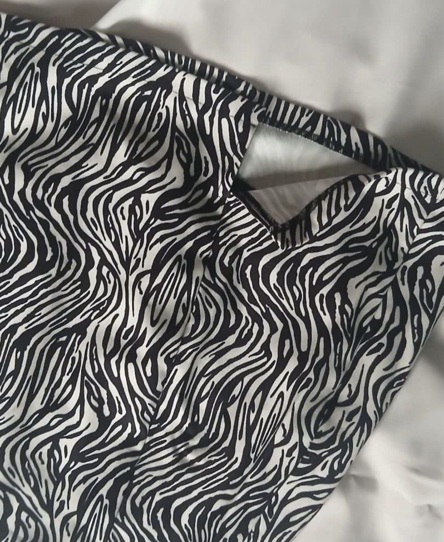 Zebra print mini skirt black and white (Category: Skirts) located in Daet. Submitted by k.declutterz (Listing ID 1466621204, Image 2). Description: - Trendy black and white zebra print - Flattering high-waisted cut with a short mini length - Stylish front slit detail near the hem - Secure back zipper closure - Easy to style with solid tops and basic tees.