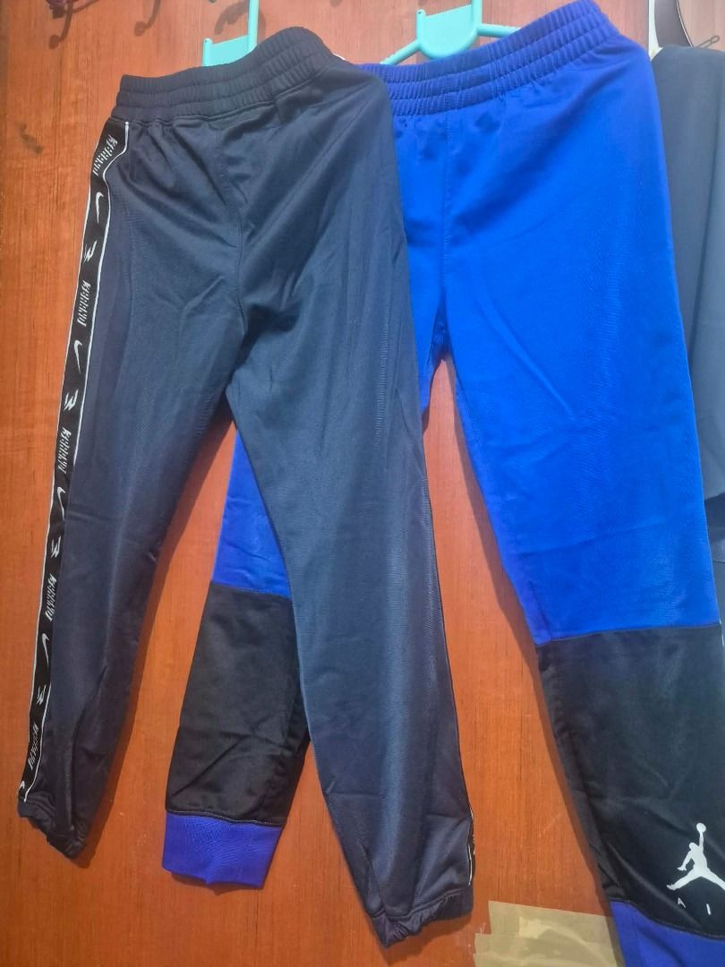 2 pants Jordan Nike Blue Black Athletic Pants (Category: Babies & Kids Fashion) located in Pasig City. Submitted by kathee88 (Listing ID 1466874032, Image 1). Description: - Brand: Jordan - Color: Royal blue and black color blocking with white details - Design: White side tape with 'Jordan' lettering, white Jumpman logo near hem - Waistband: Elastic waistband featuring Nike swoosh and 3brand logos - Material: Lightweight fabric - Condition: Great