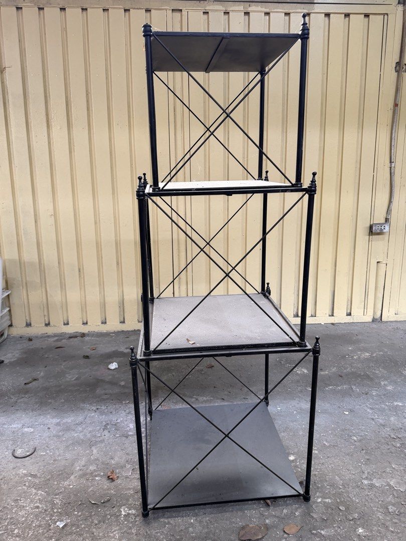 3 tier black metal display shelf unit (Category: Shelves, Cabinets & Racks) located in Las Pinas. Submitted by bluemieeeee (Listing ID 1466845534, Image 2). Description: -3 tier black metal shelving unit, approximately 4”10 feet tall - Sturdy crossbar support design on all sides for enhanced stability - Solid metal plate shelves suitable for books, plants, and display items - Great overall frame structure - Note: Shows minor dust accumulation fro