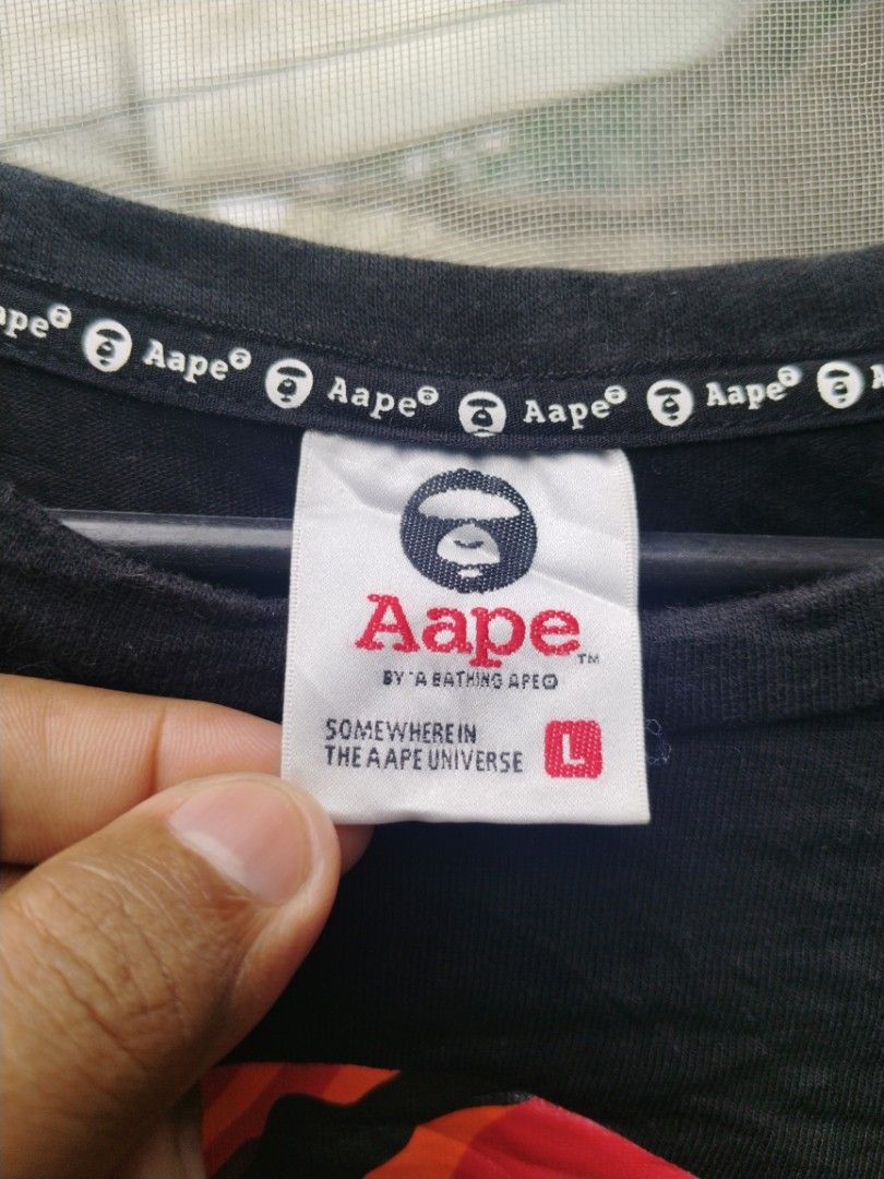 AAPE By A Bathing Ape (Category: Tshirts & Polo Shirts ) located in Legazpi City. Submitted by genobecollectives (Listing ID 1466780665, Image 3). Description: AAPEby bathing ape 500 plus sf 22 x 27 - Color: Black with iconic camo ape head graphic - Size: Large - Material: 100% premium cotton - Features: Bold white chest lettering, small upper back logo, woven sleeve cuff label, and branded interior collar tape - Condition: Brand new with size ta