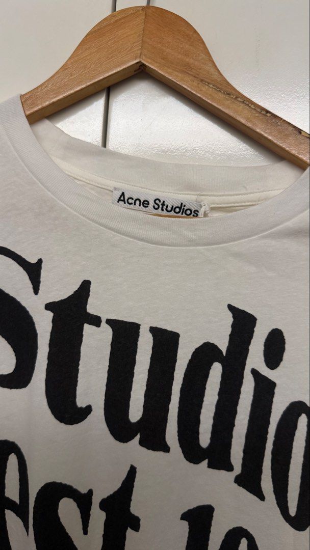 Acne Studios Long Sleeve White T-Shirt Size S (Category: Coats, Jackets and Outerwear) located in Calamba. Submitted by migsdeclutter (Listing ID 1466845928, Image 2). Description: - Brand: Acne Studios - Item: White long-sleeve tee with striking black logo print wrapping around the sleeve - Size: S Runs Big 25 x 29 - Material: Premium clean white cotton - Authenticity: Interior care tags and QR code tag attached - Condition: Excellent, well-main
