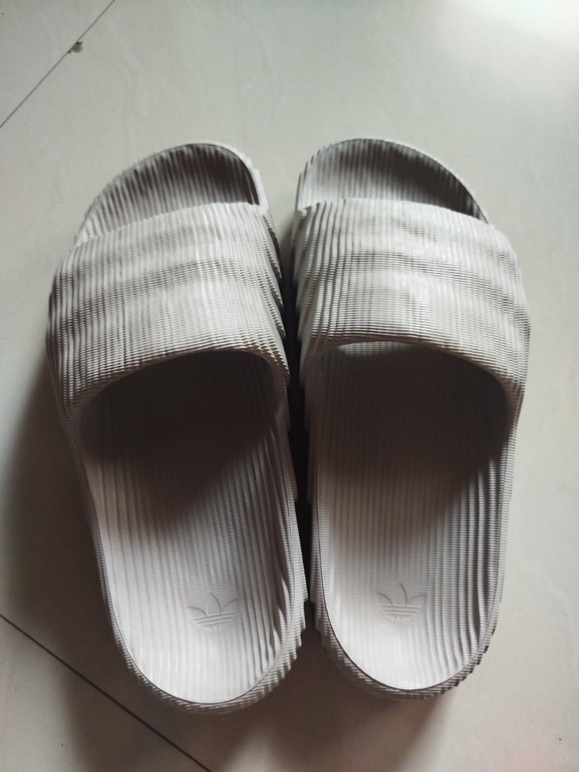 Adidas Adilette 22 Slides Gray (Category: Slippers & Slides) located in Batangas. Submitted by nolram04 (Listing ID 1466811237, Image 1). Description: - Brand/Model: Adidas Adilette 22 Slides - Color: Off White - Design: Unique topographical ridged texture on strap and footbed with embossed trefoil logo - Features: Lightweight build, slip-on comfort, and textured outsole for extra grip - Condition: Clean overall, minimal signs of handling, ready 