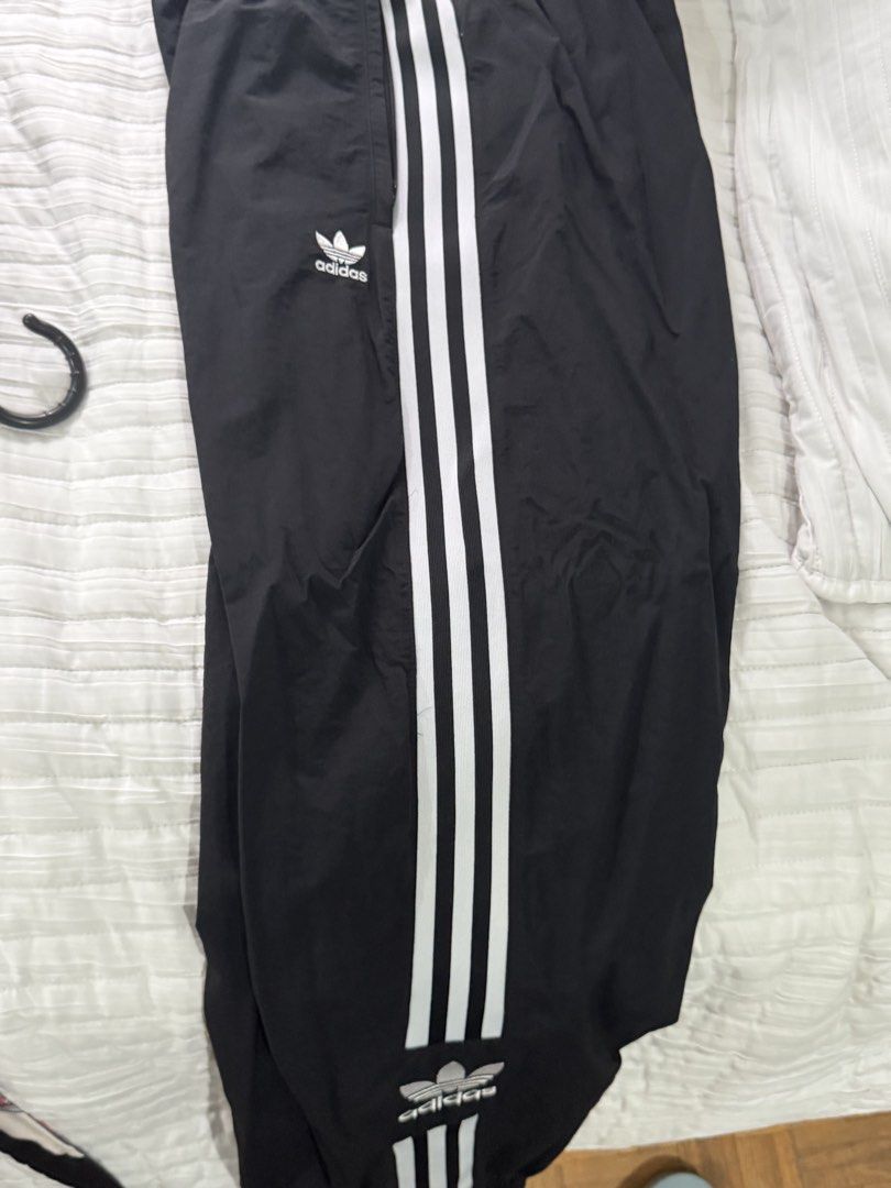 Adidas Black Track Pants With White Stripes (Category: Activewear) located in Quezon City. Submitted by afternoonstore (Listing ID 1466843316, Image 1). Description: - Brand: Adidas - Color: Black with classic white three stripes - Logo: Iconic trefoil logo near the top and bottom - Fit: Comfortable elastic waistband with adjustable drawcord - Size: D 34, F 36, I 40 - Style: Great for everyday athleisure wear and casual lounging - Condition: Exce