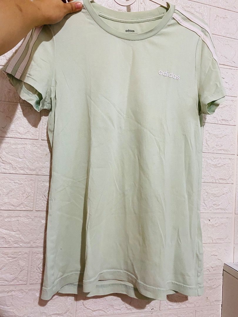 Adidas Essentials 3-Stripes Slim Tee Light Green (Category: Shirts) located in Quezon City. Submitted by johnnybaee (Listing ID 1466774062, Image 1). Description: - Brand: Adidas - Color: Light green with white 3-stripes - Details: Small rubber Adidas logo on chest, round neckline, slim fit - Material: 100% cotton - Size: Tag size Small (Bust: 84cm) - Condition: Excellent - Mode of Payment: Gotyme/QR - Shipping: Via J&T Express/lalamove (Buyer sh