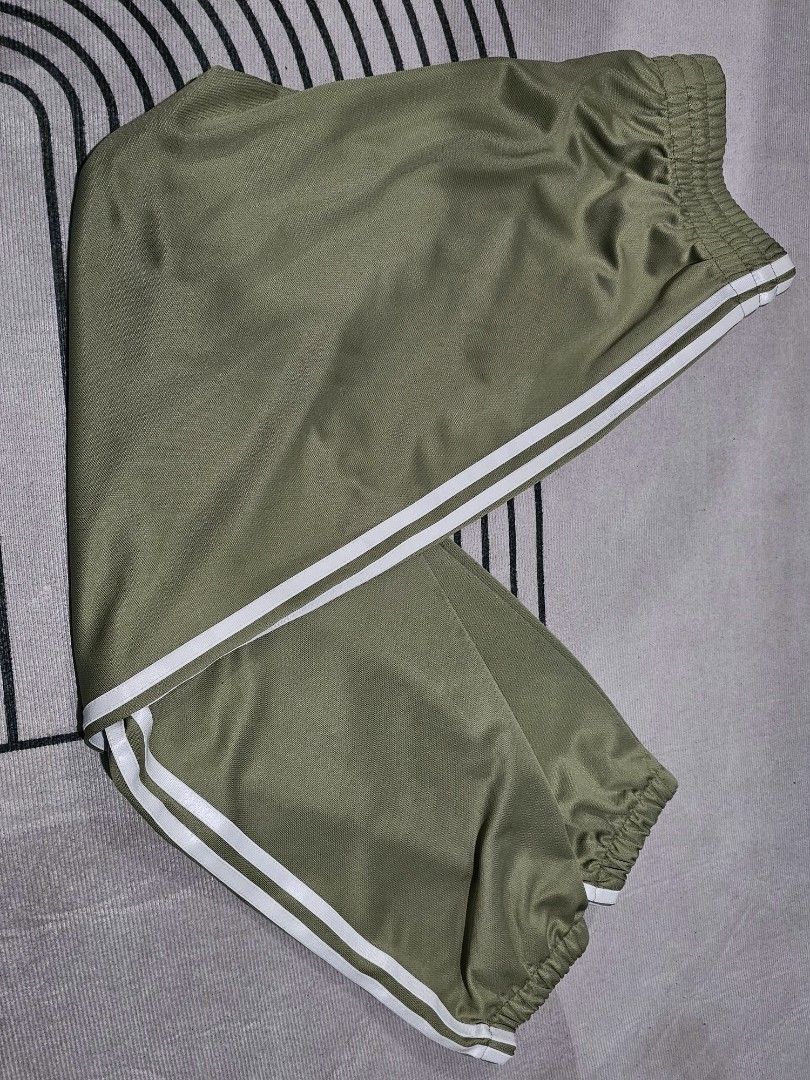 Adidas Green (Category: Joggers) located in Baguio. Submitted by kayeonlineshop (Listing ID 1466856517, Image 3). Description: green adidas track pants with the iconic 3-Stripes down the sides, resembling the adidas Firebird Loose Track Pants or similar adidas Originals Adicolor Classics styles in an olive or green colorway w 30-34 l 37.