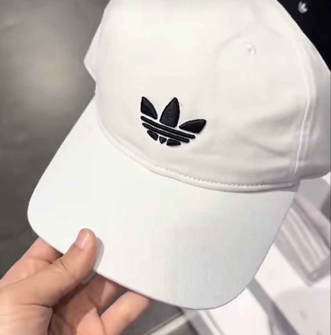 Adidas White Trefoil Baseball Cap (Category: Caps & Hats) located in Manila. Submitted by preshyyyyy_ (Listing ID 1466918920, Image 1). Description: - Brand: Adidas - Color: White with classic black embroidered trefoil logo - Design: Structured crown with a classic curved brim - Fit: Adjustable strapback style - Condition: Brand new with original store tag (PHP 1,300 retail price).