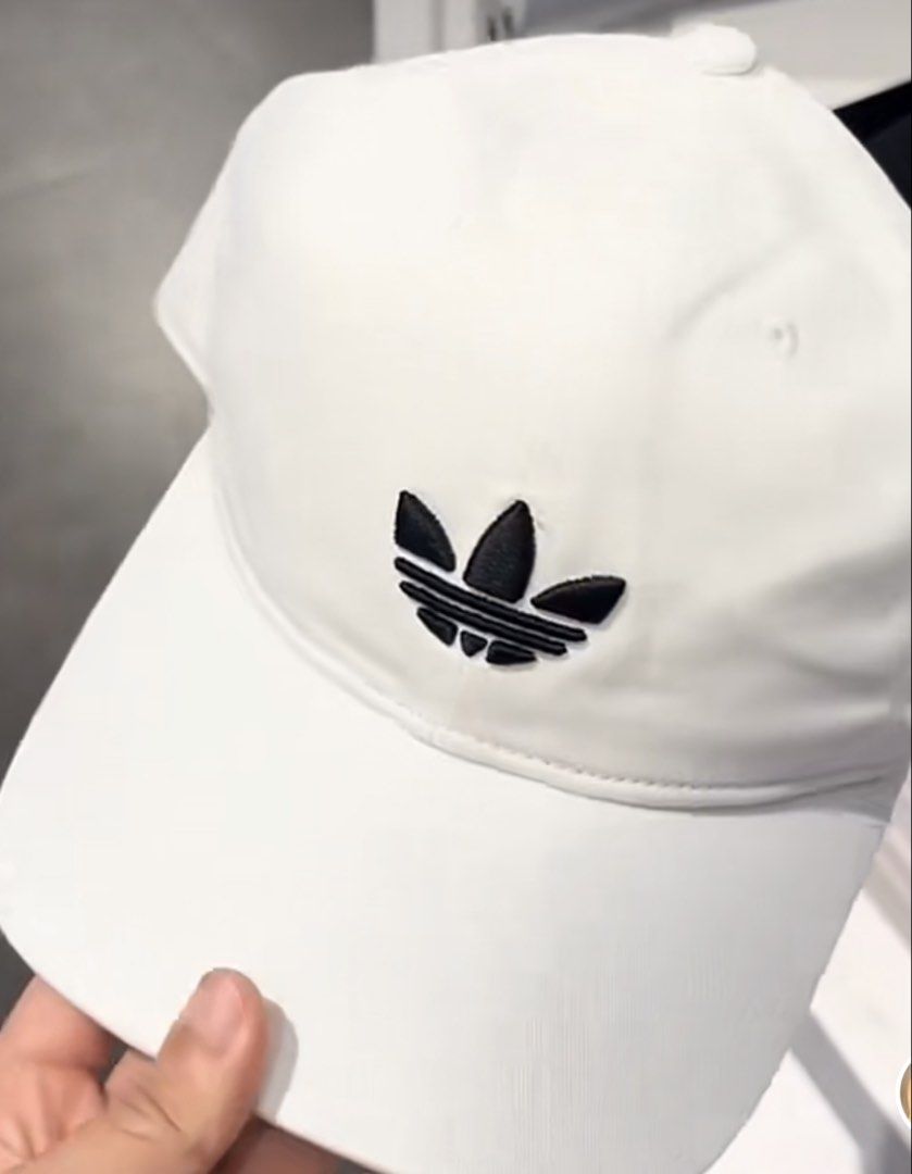 Adidas White Trefoil Baseball Cap (Category: Caps & Hats) located in Manila. Submitted by preshyyyyy_ (Listing ID 1466918920, Image 2). Description: - Brand: Adidas - Color: White with classic black embroidered trefoil logo - Design: Structured crown with a classic curved brim - Fit: Adjustable strapback style - Condition: Brand new with original store tag (PHP 1,300 retail price).