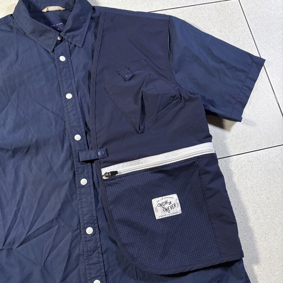 AD-LIB HK Multipocket Button-down Polo in Blue (Category: Formal Shirts) located in Manila. Submitted by yama_archive (Listing ID 1466907181, Image 3). Description: AD-LIB HK Multipocket Button-down Polo in Blue Dimes (inches starting from 0) — - Size on tag: L - Width: 23.5 - Length: 28.5 - Shoulders: 22 - Sleeves: 10 - Fabric: Nylon ₱1500 Issues: ❌ Condition: 10/10 Color Rate: 10/10.