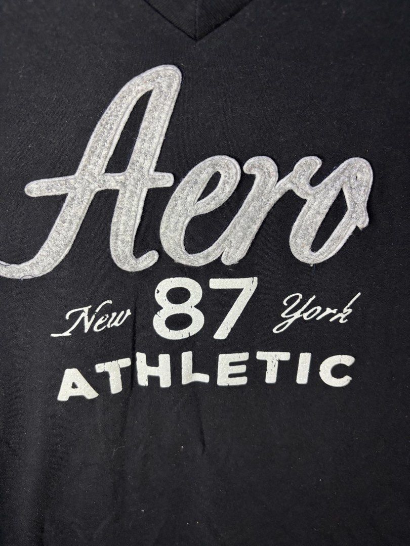 Y2K AEROPOSTALE T SHIRT (Category: Tshirts & Polo Shirts ) located in Bayambang. Submitted by lo_keythrifting (Listing ID 1466828370, Image 2). Description: - Brand: Aeropostale - Condition: Good as new - Dimes: 15.5*25 - Color rate: 10/10 - No issue - Color: Black - Size: S/P (Slim Fit) - Material: 60% Cotton, 40% Polyester - Design: V-neck with 'Aero New York 87 Athletic' front graphic - Condition: Brand new / Excellent pre-loved - Care: Machin