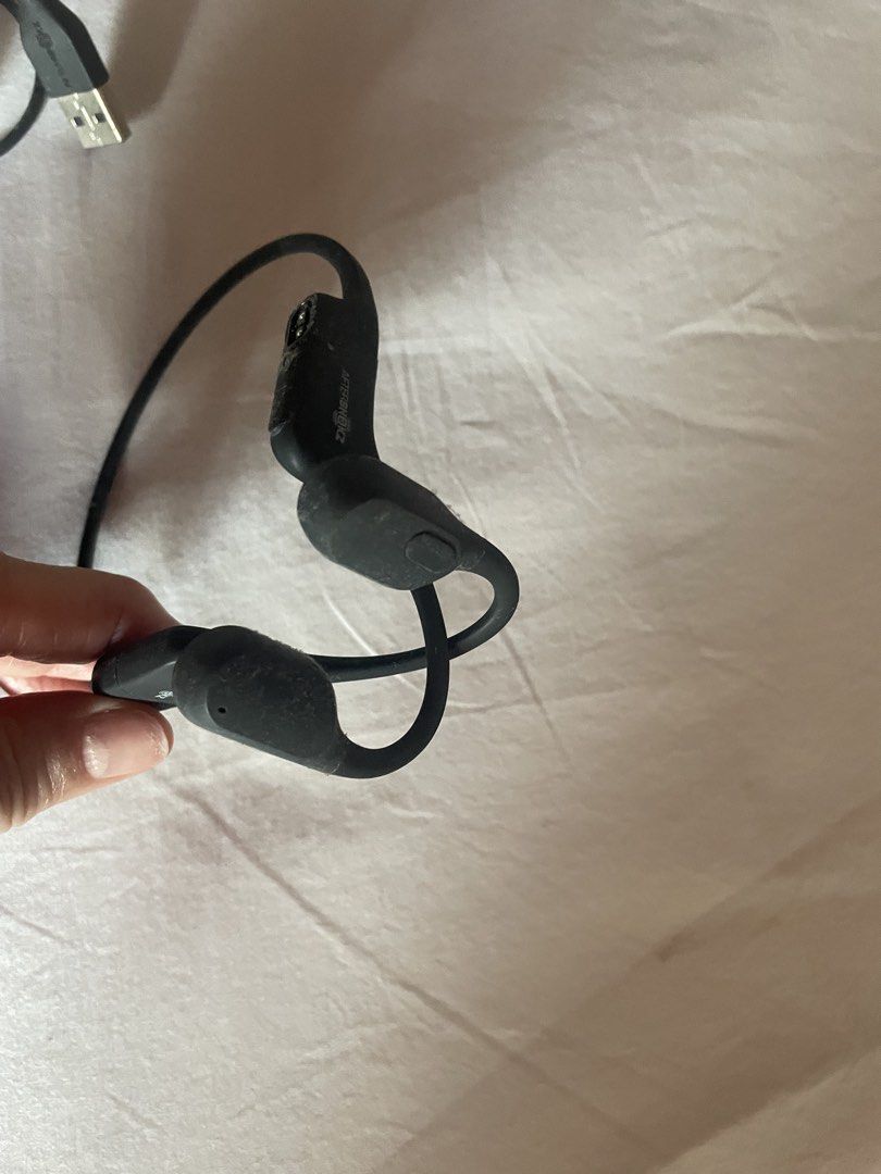 AfterShokz OpenEar Wireless Bone Conduction Headphones (Category: Headphones & Headsets) located in Quezon City. Submitted by deadmit (Listing ID 1466798584, Image 2). Description: - Brand: AfterShokz wireless bone conduction headphones - Color: Black - Key Feature: Open-ear design keeps ears clear, perfect for running and cycling outdoors - Inclusions: Original charging cable, silicone storage case, and a pair of foam earplugs Wont charge.