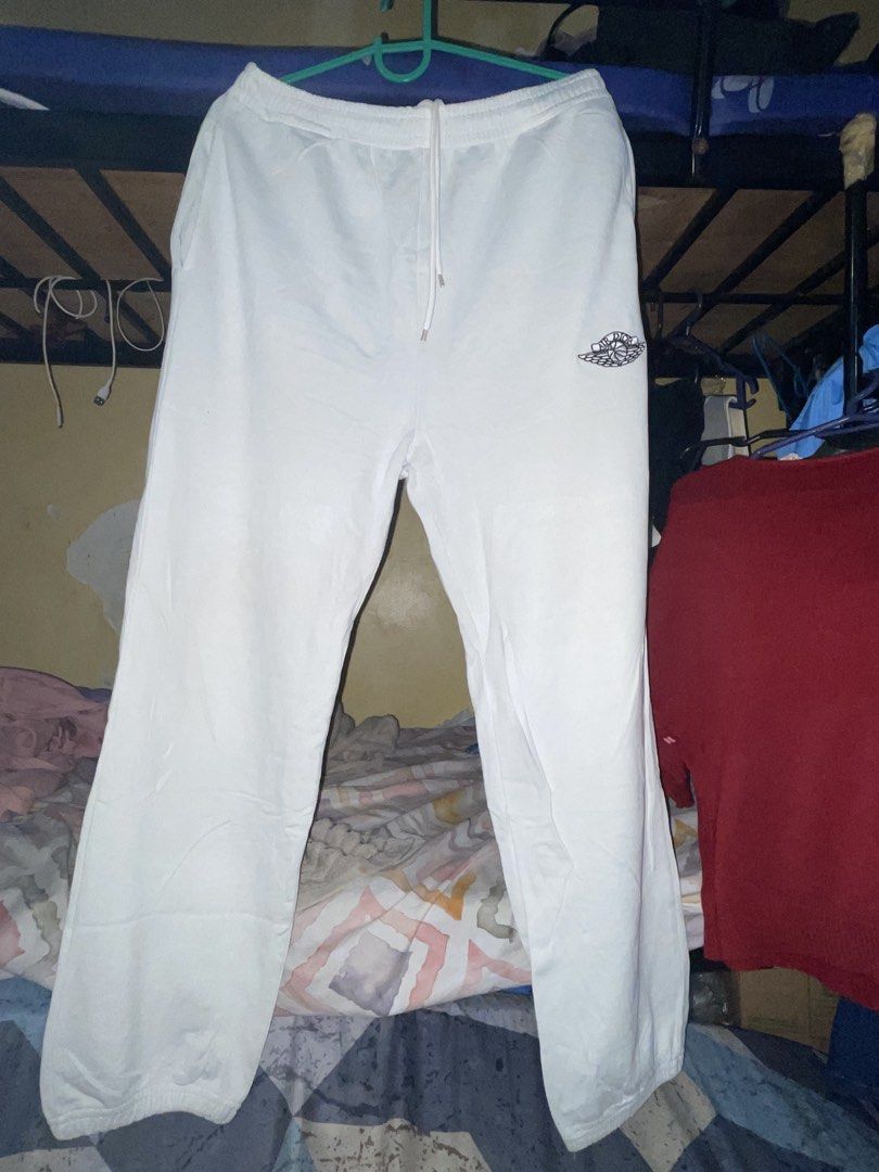 Air Dior White Sweatpants Joggers (Category: Luxury Apparel) located in Manila. Submitted by jabjabthriftplace (Listing ID 1466807658, Image 1). Description: - Authentic Air Dior collaboration sweatpants in pristine white - Features iconic embroidered Air Dior wing logo on the left leg - Comfortable elastic waistband with adjustable drawstring - Stylish cuffed ankles and relaxed fit for daily wear - Soft, premium fabric for ultimate comfort - Com