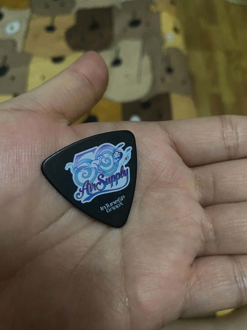 Air supply guitar pick Russell (Category: Music Accessories) located in Paranaque City. Submitted by arckadyo (Listing ID 1466775338, Image 2). Description: FOR SALE: AIR SUPPLY GUITAR PICK 🎸 This guitar pick was personally handed to me by Russell Hitchcock of Air Supply at NAIA Terminal 1 when they were here in the Philippines for their 2026 concert. A very special and rare souvenir for Air Supply fans and collectors. ❤️ Personally received fro