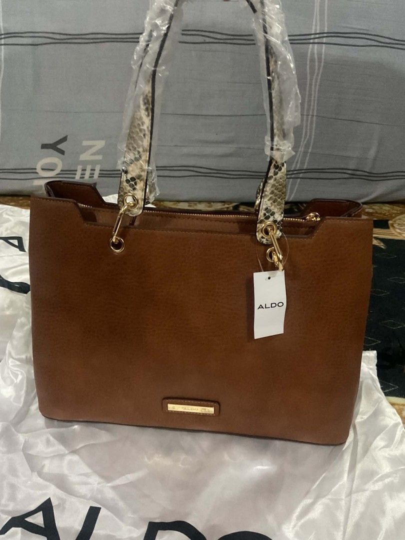 Aldo bag (Category: Tote Bags) located in Dasmarinas. Submitted by erljapan (Listing ID 1466915338, Image 1). Description: The item in the image is the ALDO Hareli Tote Bag (shown in a medium beige/tan synthetic finish with a patterned strap). [1, 2] Product Details: Brand: ALDO Style: Hareli Tote Bag Material: Synthetic / vegan leather Dimensions: Approximately 37.5 cm (L) × 13.5 cm (W) × 25.5 cm (H) Features: Top-zip closure, structured 3-compa
