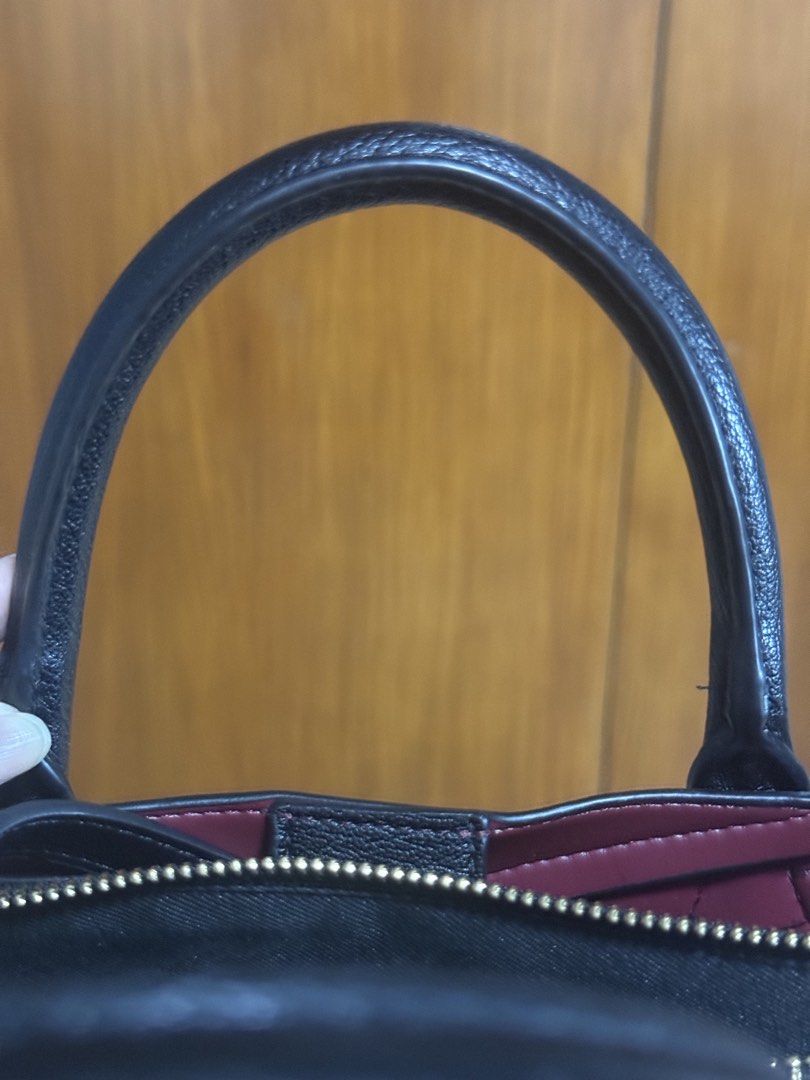 ALDO Black Structured Handbag with Shoulder Strap (Category: Luxury Bags & Wallets) located in San Pedro. Submitted by cutiepagong (Listing ID 1466966825, Image 3). Description: Black structured handbag from ALDO with gold hardware. Contrasting deep red lining inside. Includes top handles and an adjustable black shoulder/cross body strap with a buckle. Multiple zippered compartments keep everything organized..