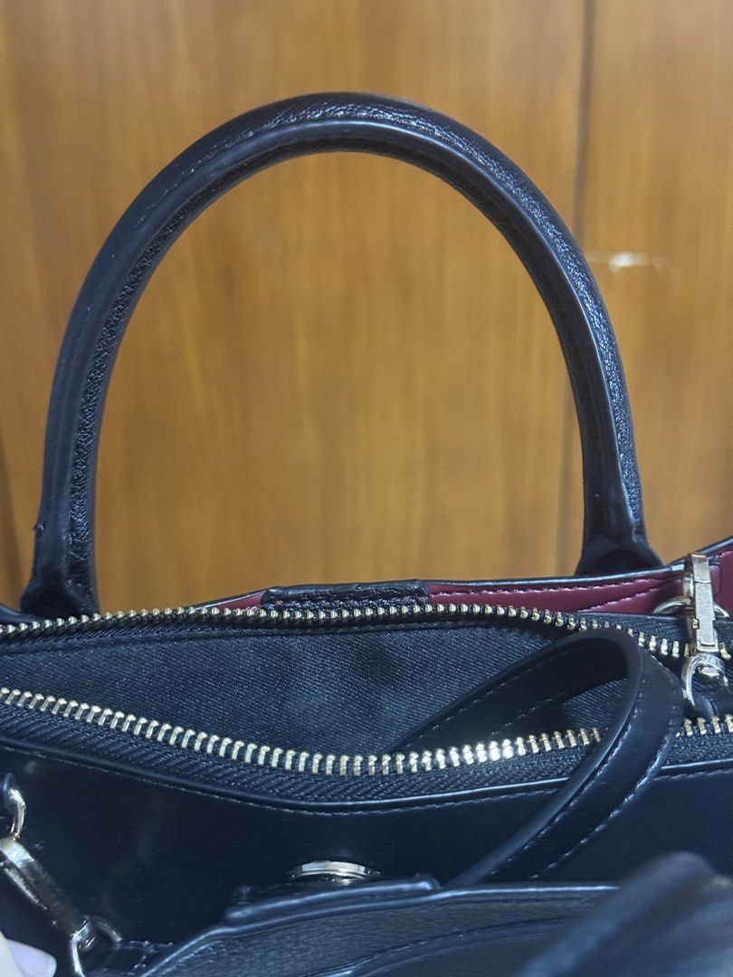ALDO Black Structured Handbag with Shoulder Strap (Category: Luxury Bags & Wallets) located in San Pedro. Submitted by cutiepagong (Listing ID 1466966825, Image 2). Description: Black structured handbag from ALDO with gold hardware. Contrasting deep red lining inside. Includes top handles and an adjustable black shoulder/cross body strap with a buckle. Multiple zippered compartments keep everything organized..