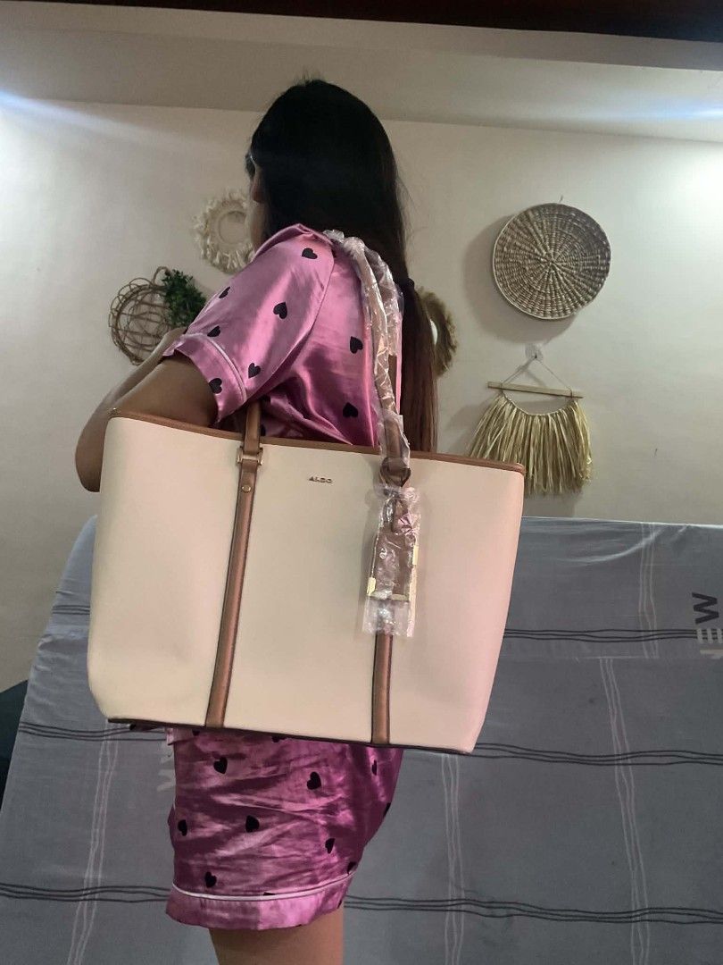 Aldo tote bag (Category: Shoulder Bags) located in Dasmarinas. Submitted by erljapan (Listing ID 1466913703, Image 3). Description: This item is the ALDO Elamaryn Tote Bag in a bone/tan or beige and brown colorway. Product Details Brand: ALDO Style: Top-zip tote bag with a structured silhouette Color: Bone / Beige with brown trim and matching charm detail Approximate Dimensions: Height: 38 cm (approx. 15 inches) Length: 43 cm (approx. 17 inches) 
