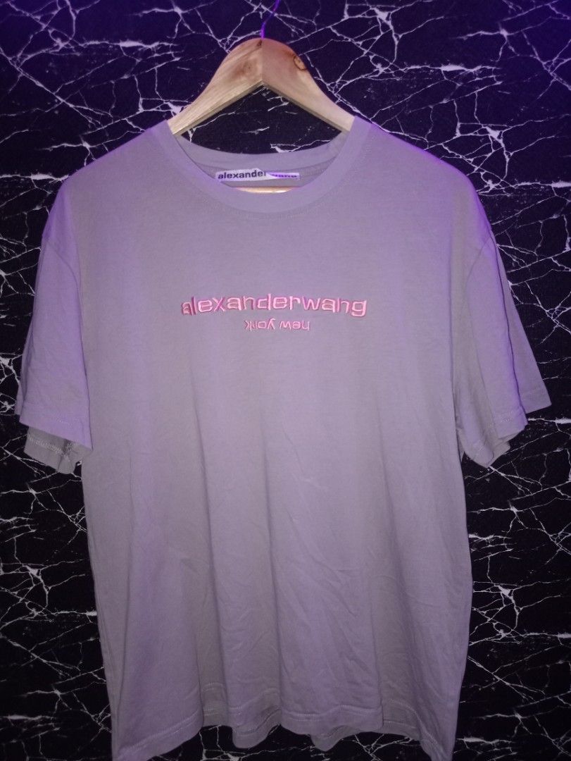 Alexander Wang Logo T-shirt Size M (Category: Shirts) located in Manila. Submitted by naixhrift (Listing ID 1466847213, Image 1). Description: - Brand: Alexander Wang Shirt - Size: M to L - Color: Grey with pink embroidered chest logo and upside-down 'new york' lettering - Origin: Made in Turkey - Length 27 - Width 22 880 plus ship jnt courier payment on gcash for trusted only manila area.