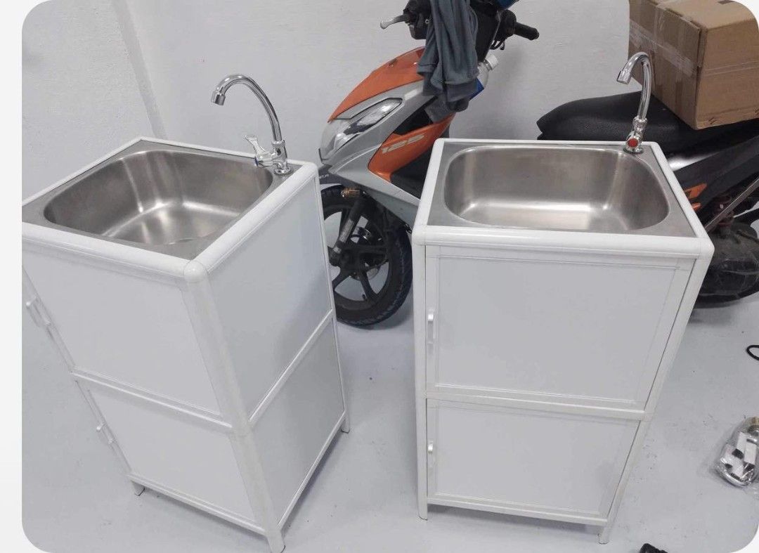 Aluminum Kitchen Sink Cabinet With Storage (Category: Bathroom & Kitchen Fixtures) located in Manila. Submitted by jamfrimzy089458 (Listing ID 1466828377, Image 1). Description: - Dimensions: 46cm (L) x 40cm (W) x 83cm (H) - Durable aluminum frame in white with stylish frosted glass doors and floral pattern - Includes stainless steel basin, faucet, and complete plumbing set - Features double-tier interior storage and a convenient open bottom shel