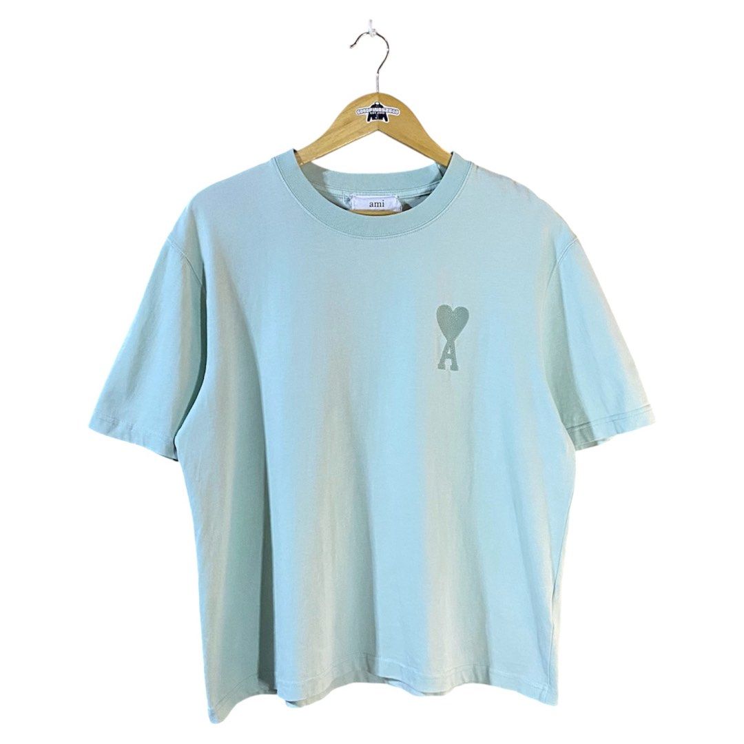 Ami Tiffany Shirt (Category: Luxury Apparel) located in Baguio. Submitted by goodfinds2600v2 (Listing ID 1466892856, Image 1). Description: Size on tag: S fits M Dimensions: L-25.5 W/Bust-22 Description: unisex, tiffany color, boxy fit Condition: Very good Issue/s: small bleach stain dots .