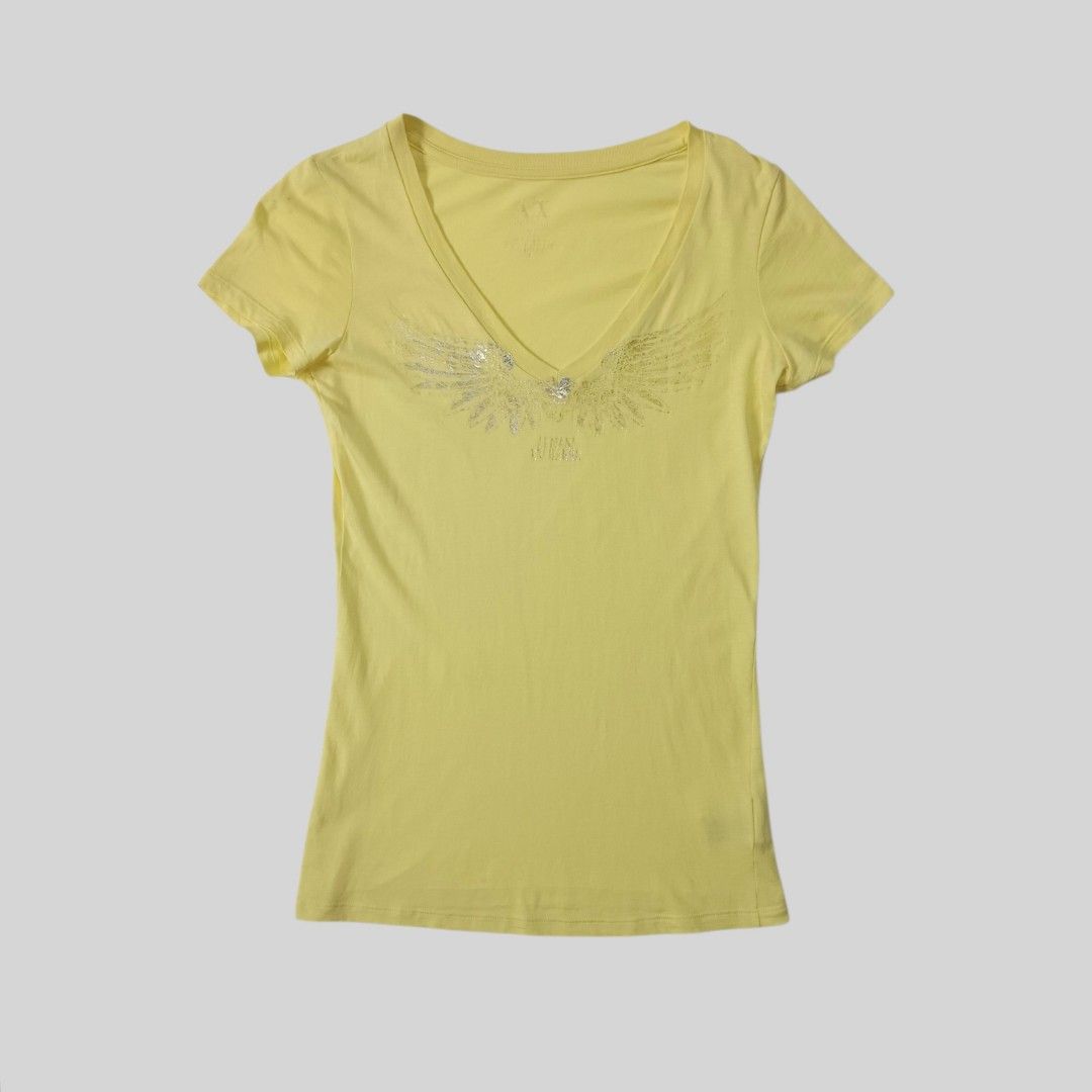 Armani Exchange Silver Wings Top (Category: Luxury Apparel) located in Davao. Submitted by thriftbuddy (Listing ID 1466814157, Image 1). Description: size xs on tag width 14" length 24" verygood condition 9/10 colorate scratch/hole see photos for details still presentable to wear.