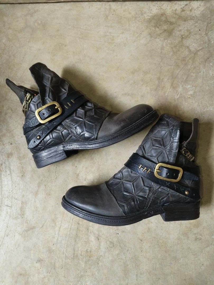A.S 98 Archival post apocalyptic leather boots (Category: Boots) located in Davao. Submitted by vndrgd (Listing ID 1466782866, Image 1). Description: - Grey leather ankle boots with unique geometric quilted pattern - Double side straps with large brass buckle detail - Convenient side zipper closure with matching brass hardware - Contrasting dark grey toe cap and low heel - Sturdy rubber sole for durability and comfort.