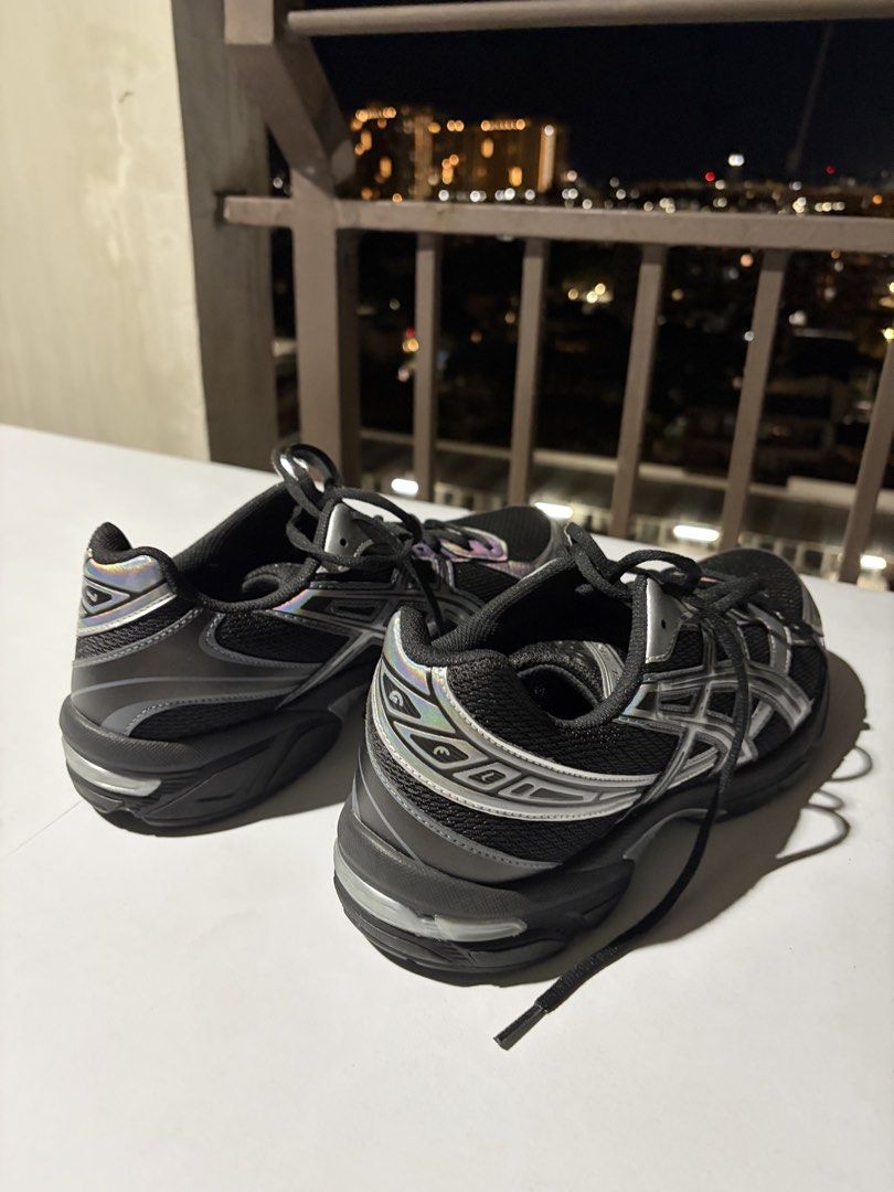ASICS Gel-NYC Black Metallic Silver (Category: Casual Shoes) located in Taguig. Submitted by JBT1968 (Listing ID 1466929388, Image 2). Description: - Brand/Model: ASICS running shoes - Color/Design: Black mesh upper with silver overlays and eye-catching iridescent rainbow trim - Sole: Chunky black rubber sole with excellent tread for grip - Inclusion: Comes with laces - Style: Trendy chunky silhouette, great for comfortable everyday wear.